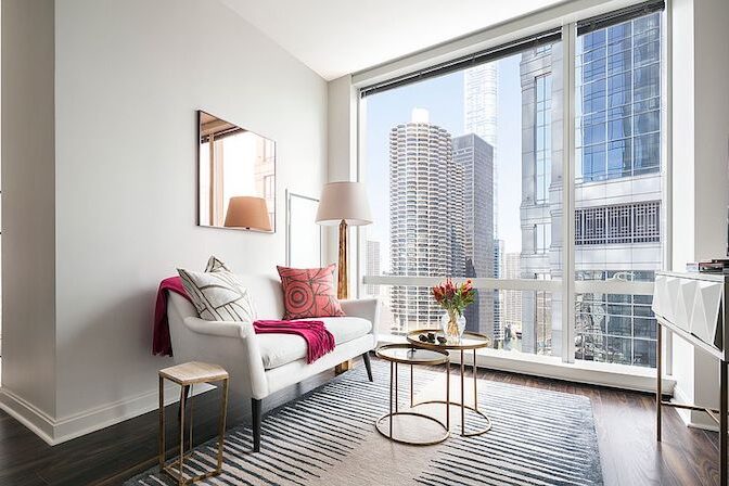 A living room with sunlight getting in through the windows